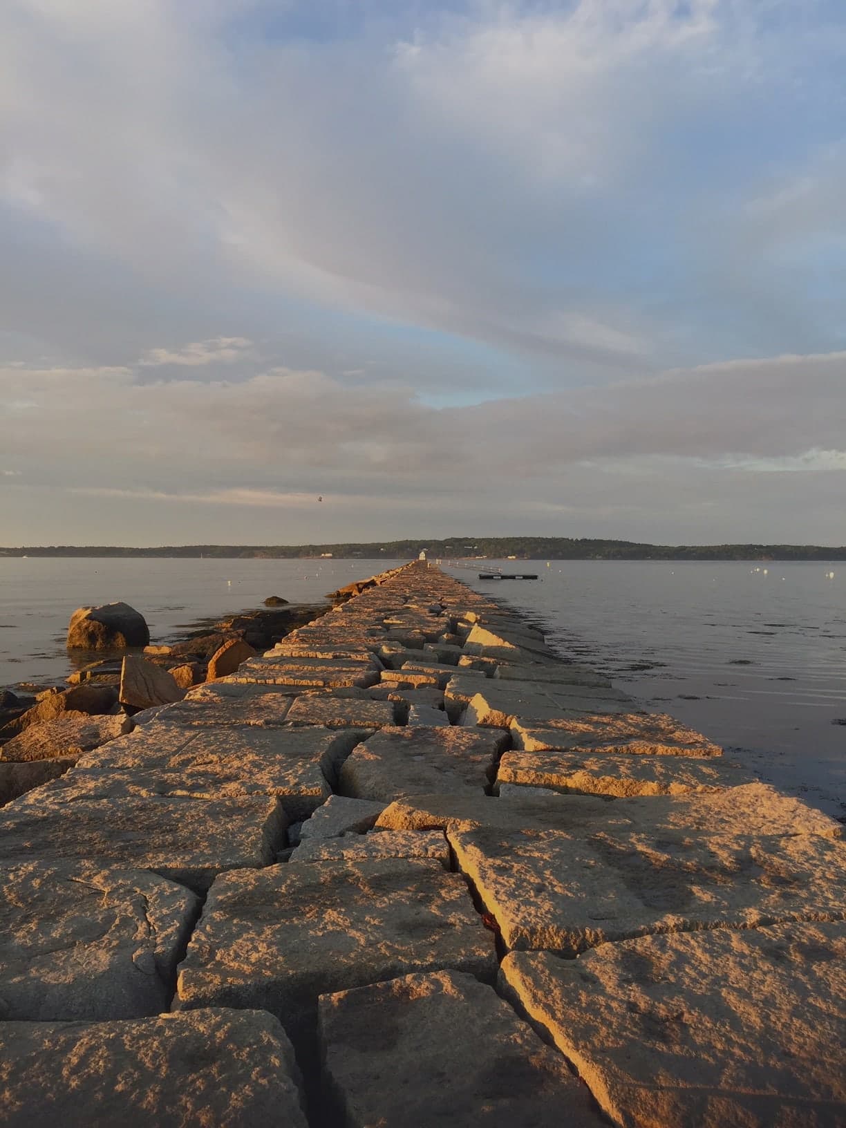 The Rockland breakwater stretching into the sea at golden hour